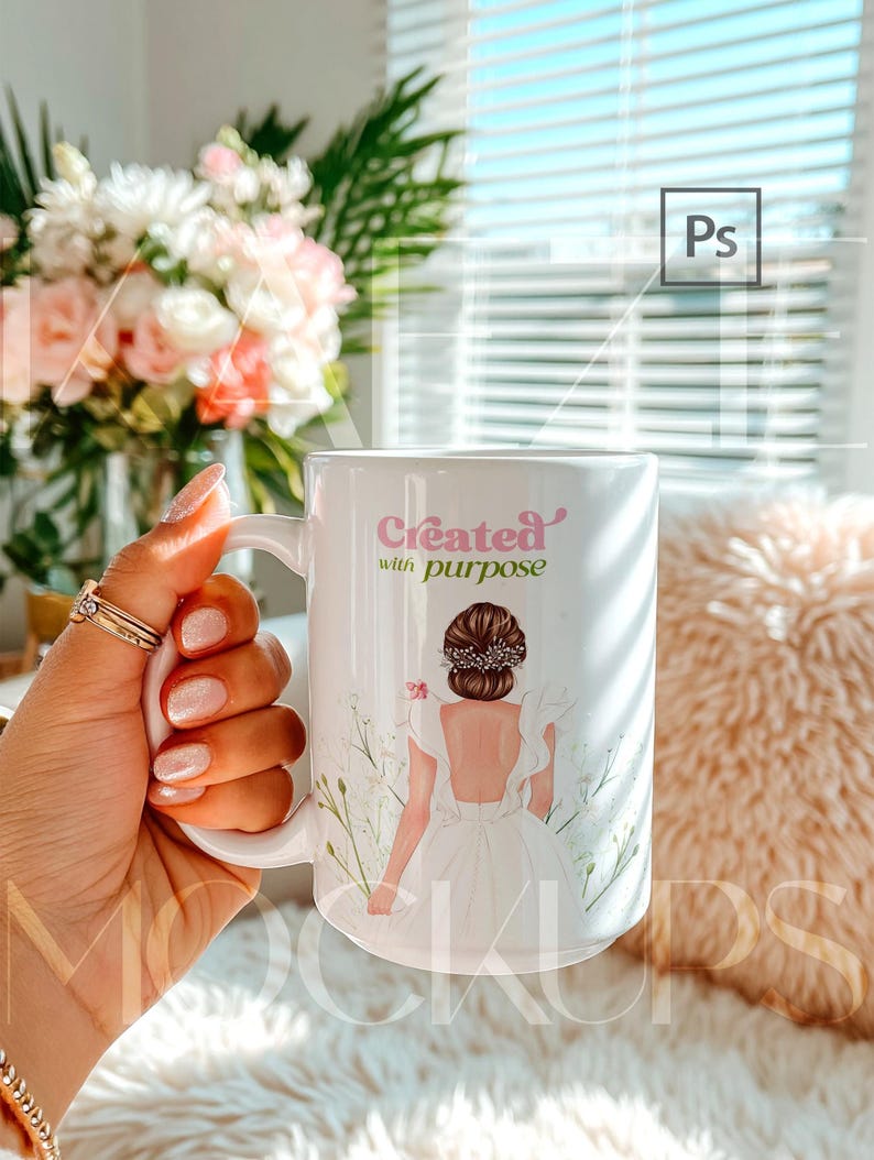 15oz mug mockup displayed as a hand held coffee cup featuring an illustrated artwork example on the mug body. Styled in a warm, trendy interior with soft textures and daylight. Mug mockup supports easy design replacement using PSD smart object and Canva drag and drop template. High quality mugs mockup for branding and gift product listings.