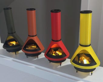 May include: Four miniature fireplaces in different colors, including green, orange, red, and yellow, with glowing orange embers inside.