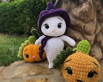 May include: Three crocheted Halloween decorations: a white ghost wearing a purple hat, and two orange pumpkins with green stems and black eyes.