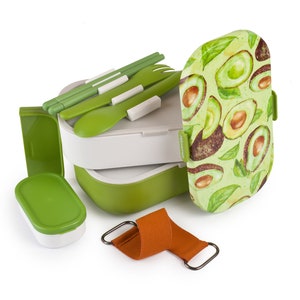 May include: A green and white lunchbox with a removable top and a separate container. The lunchbox has a pattern of avocado slices on the lid. The lunchbox comes with a set of green utensils and a brown strap.