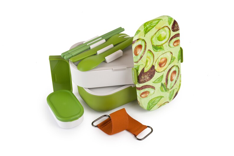 May include: A green and white lunchbox with a removable top and a separate container. The lunchbox has a pattern of avocado slices on the lid. The lunchbox comes with a set of green utensils and a brown strap.