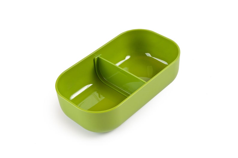 May include: A green plastic divided lunch container with two compartments. The container is empty and ready to be filled with food.