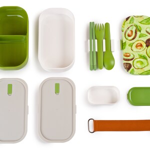 May include: A green and white lunchbox set featuring an avocado pattern. The set includes a lunchbox, a container, a lid, a set of chopsticks, a fork, a spoon, and a carrying strap.