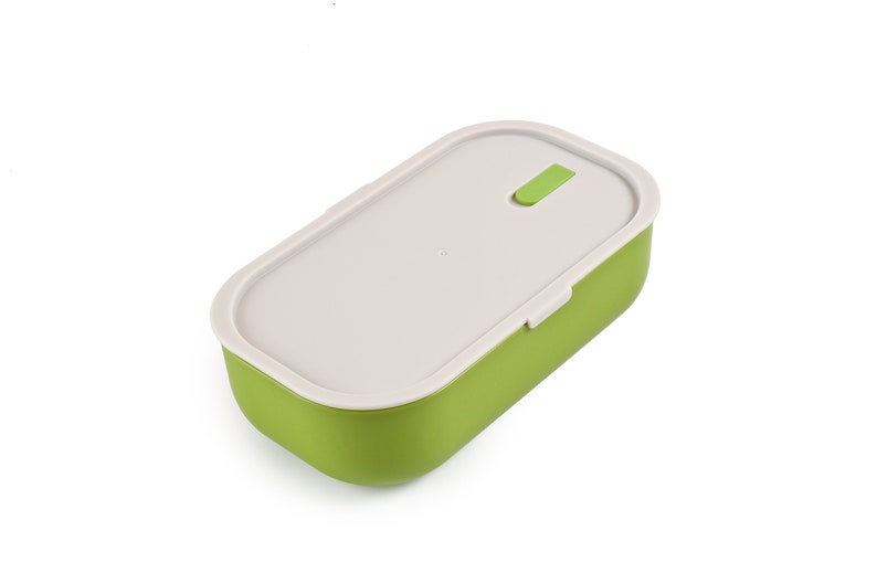 May include: A green and white rectangular lunchbox with a latch on the top.