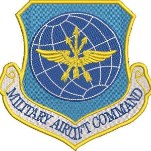 May include: Embroidered patch featuring the Military Airlift Command emblem. The patch has a blue background with a globe and gold wings in the center. The text "MILITARY AIRLIFT COMMAND" is embroidered in white on a curved banner.