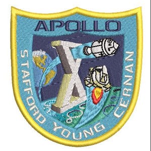 May include: Embroidered patch featuring the Apollo X mission emblem. The patch has a blue background with a gold border. The design includes a stylized "X", a rocket, and the Earth. Text includes "APOLLO", "STAFFORD", "YOUNG", and "CERNAN".