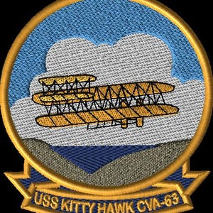 May include: Embroidered patch featuring a biplane in shades of yellow and brown against a backdrop of clouds and blue sky. The patch is circular with a gold border and includes the text "USS KITTY HAWK CVA-63" in gold lettering on a blue banner.