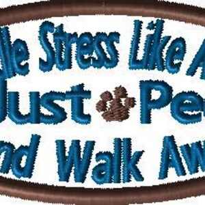May include: An oval design with the text "Handle Stress Like A Dog Just Pee And Walk Away" in blue, framed by a brown border. Brown paw prints are on either side of the text.