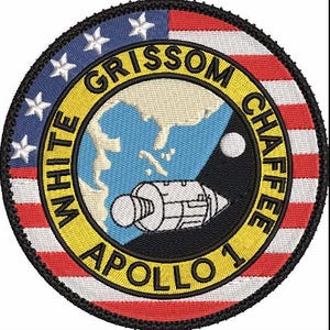 May include: Embroidered patch featuring the Apollo 1 mission insignia. The design includes a map of the Americas, a spacecraft, and the names "GRISSOM CHAFFEE" and "WHITE APOLLO 1." The patch has a circular shape with a black border and incorporates red, white, blue, and yellow colors.