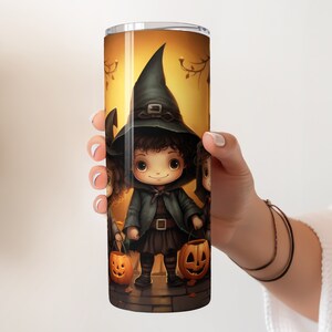 May include: A stainless steel tumbler featuring a Halloween design with three children dressed as witches holding jack-o'-lanterns. The design is colourful and whimsical, with a warm orange background.
