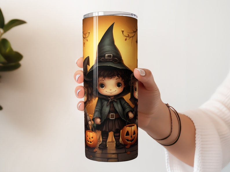 May include: A stainless steel tumbler featuring a Halloween design with three children dressed as witches holding jack-o'-lanterns. The design is colourful and whimsical, with a warm orange background.