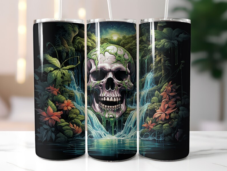 May include: A black tumbler featuring a vibrant illustration of a skull with a waterfall backdrop. The skull is detailed with green vines and surrounded by lush green foliage and orange flowers. A white straw is inserted into the tumbler.