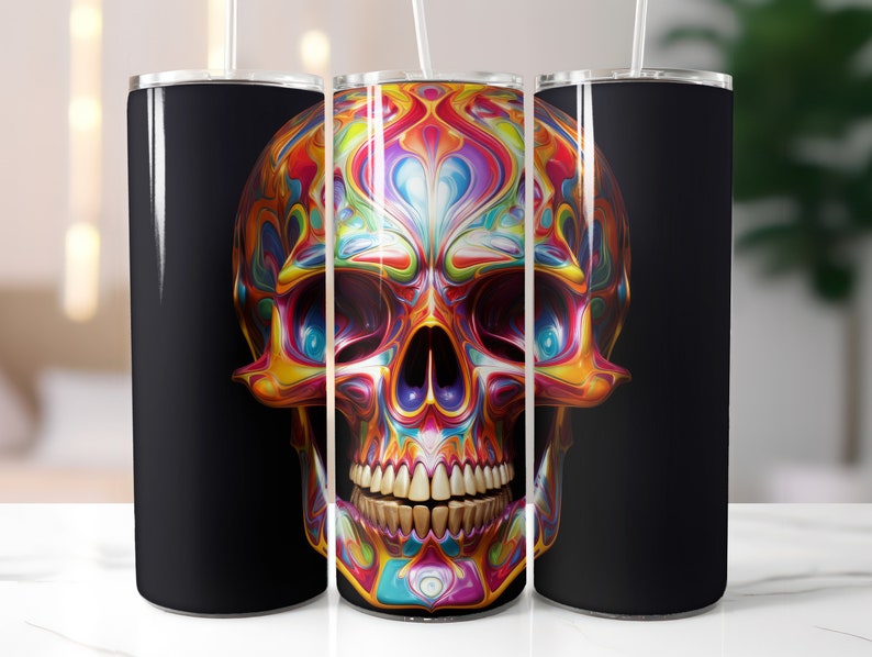 May include: A set of three stainless steel tumblers with a vibrant, colorful skull design. The skull features a psychedelic pattern of swirling blues, yellows, oranges, and purples. The background of the tumblers is black, and each has a white straw.
