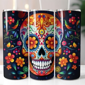 May include: Three stainless steel tumblers with a Day of the Dead sugar skull design. The skull is decorated with colorful flowers and patterns on a black background. Each tumbler has a white straw.