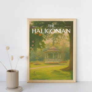 Puede incluir: Una impresión enmarcada de la portada de la revista "The Haligonian". La imagen representa una escena de parque con un mirador, árboles y una zona de césped. El título de la revista está en letras blancas, con la fecha "Julio 2014".