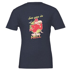 May include: Navy blue t-shirt with a cartoon red bird design and the text "See you in HELL". The bird is holding a cigarette. The text is in yellow and red.