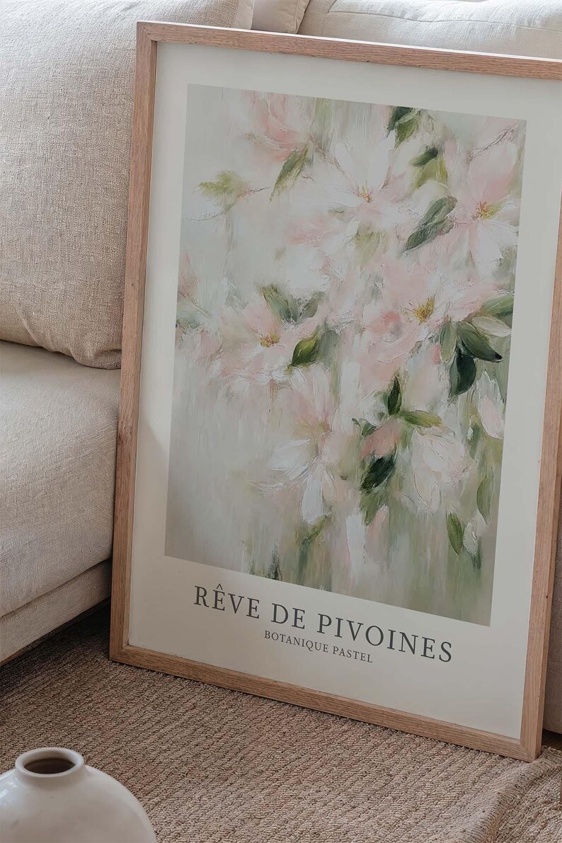 May include: A framed art print featuring a soft, impressionistic floral painting. The artwork showcases delicate pink and white flowers with green leaves against a muted background. The print is titled "R&ecirc;ve de Pivoines" and "Botanique Pastel".