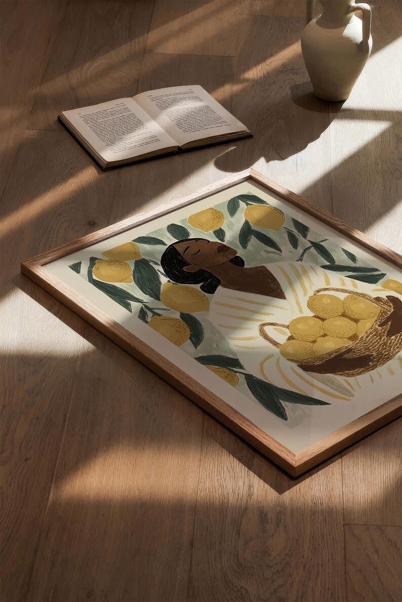 May include: A framed illustration of a person with brown skin, wearing a white and yellow striped shirt, holding a basket of lemons. The background is a green and yellow lemon tree.