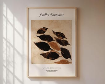Peut inclure: Une affiche encadrée présentant une composition abstraite de feuilles d'automne en nuances de marron et de noir sur un fond beige. Le texte "feuilles d'automne" est en haut, avec "ATELIER COLLECTION" et d'autres textes en bas.