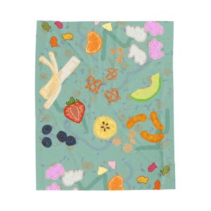May include: A teal blanket with a whimsical food pattern. The design includes illustrations of pretzels, strawberries, blueberries, orange slices, bananas, and other snacks. The blanket has a playful, colorful aesthetic, perfect for a child's room or a picnic.