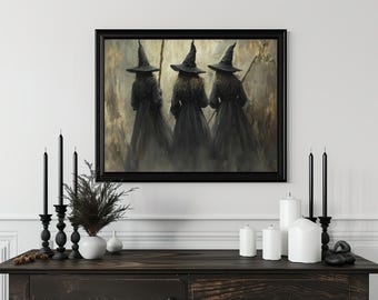 Peut inclure: Une peinture encadrée représentant trois sorcières portant des capes noires et des chapeaux pointus, marchant dans une forêt. La peinture est sur un fond de tons bruns et beiges doux.