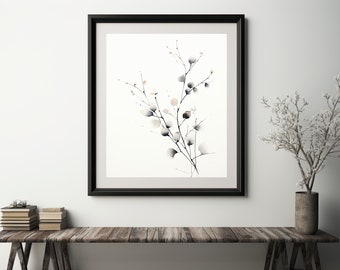 May include: A black framed print of a watercolor painting of a delicate branch with small white and gray blossoms. The print is hanging on a white wall above a wooden table.