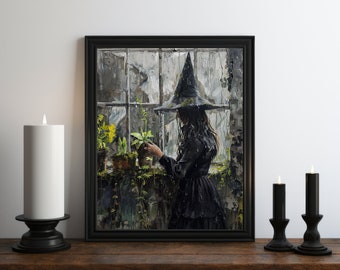 May include: A framed art print depicts a person in a black dress and witch hat tending to plants by a window. The artwork is in a dark, moody style with a black frame. Two black candle holders with candles are on a wooden surface.