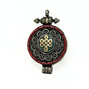 Tibetan Endless Knot pendant handmade in Nepal.