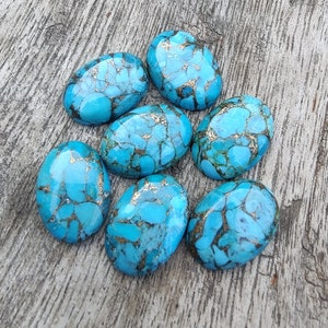 May include: Seven oval-shaped turquoise cabochons with a blue and gold marbled pattern.