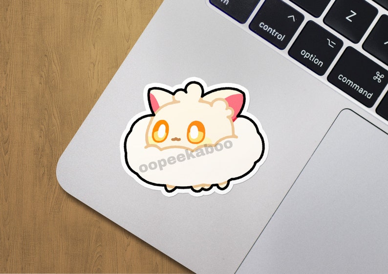 May include: A white fluffy sticker with a cartoon animal with pink ears and yellow eyes. The sticker has the text "oopeekaboo" on it.