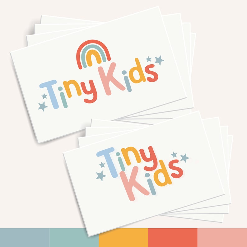 May include: A stack of white business cards with a colorful logo that says "Tiny Kids" with a rainbow and stars.