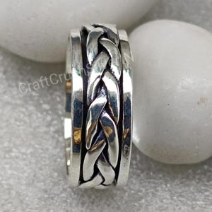 Anillo giratorio con nudo celta trenzado de plata de ley