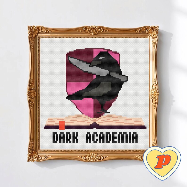 May include: Cross-stitch artwork in a gold ornate frame. The design shows a black crow with a knife, set against a pink shield, above an open book. The text "DARK ACADEMIA" is below the book.