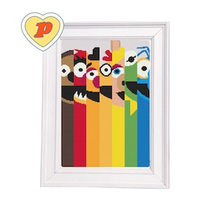 May include: A framed cross-stitch artwork featuring a colorful design of cartoon character faces. The characters are arranged vertically with a rainbow color scheme. The artwork is in a white frame and includes a yellow heart-shaped logo with a letter "P".