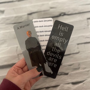 May include: Three bookmarks with different designs. The first bookmark is white with black text that reads "I am not insane" repeated multiple times. The second bookmark features a black and white silhouette of a person with the name "A. Warner" at the top. The third bookmark is black with white text that reads "Hell is empty all the devils are here."