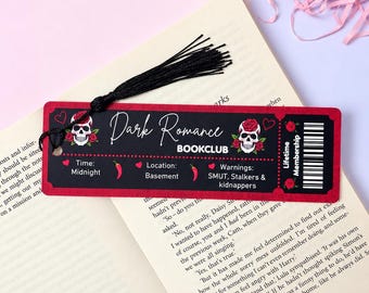 May include: A rectangular red bookmark with a black tassel featuring the text Dark Romance BOOKCLUB, two skull illustrations with red roses, and details listing Time: Midnight, Location: Basement, and Warnings: SMUT, Stalkers & kidnappers.