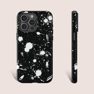 Puede incluir: Funda de teléfono negra con un diseño de pintura salpicada blanca.