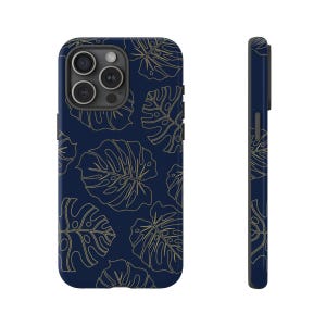 May include: A navy blue phone case with a gold outline of tropical leaves pattern.