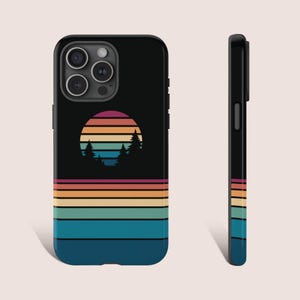 May include: A black phone case with a retro sunset design featuring a colorful striped sun and silhouette trees. The case has a black background with a colorful striped pattern at the bottom.