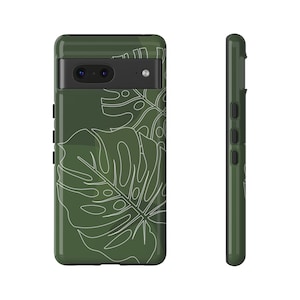May include: A green phone case with a white outline of tropical leaves. The case has a camera cutout and a cutout for the phone's buttons.