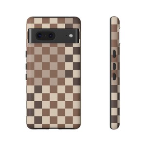 May include: A brown and beige checkered phone case with a black camera cutout.
