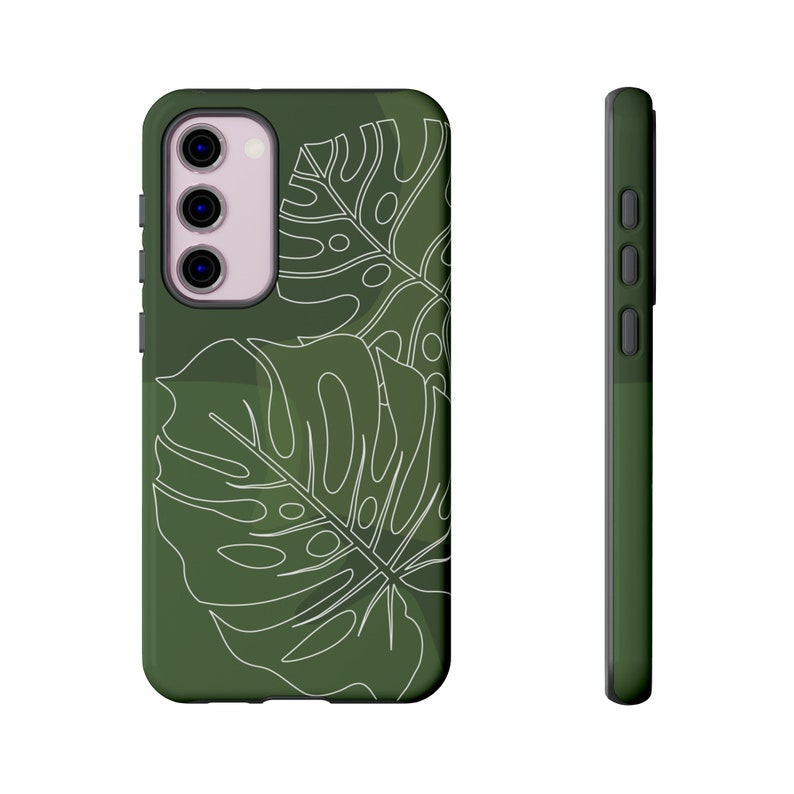 May include: A green phone case with a white outline of tropical leaves. The case has a camera cutout and a raised button on the side.