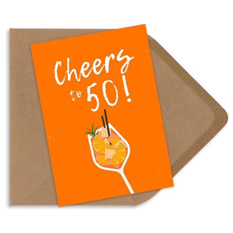 May include: Orange birthday card with the text "Cheers to 50!" and a cartoon illustration of a glass of orange juice with a straw and orange slices.