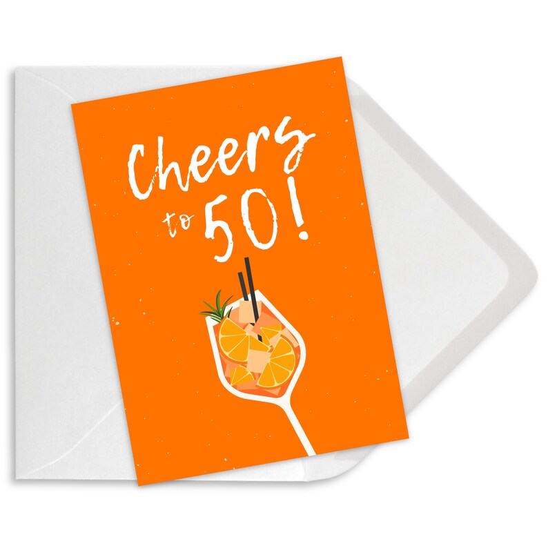 May include: Orange card with the text "Cheers to 50!" in white. An illustration of a glass of orange juice with a straw and orange slices is below the text.