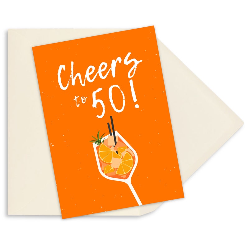 May include: Orange birthday card with the text "Cheers to 50!" in white. The card features a cartoon illustration of a glass of orange juice with a sprig of rosemary and orange slices.
