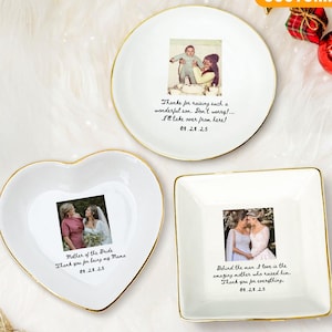 May include: Three white ceramic dishes with gold rims, each featuring a photograph and text. The dishes are round, heart-shaped, and square. Text includes phrases like "Thank you for being my Mama" and "Thank you for everything."