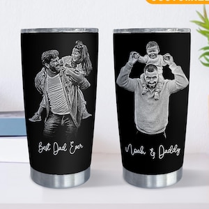 May include: Two black stainless steel tumblers with custom engraved photos. One features a man carrying a woman, the text "Best Dad Ever." The other shows a man with a child, text "Noah & Daddy." The tumblers have a "Customized" label.