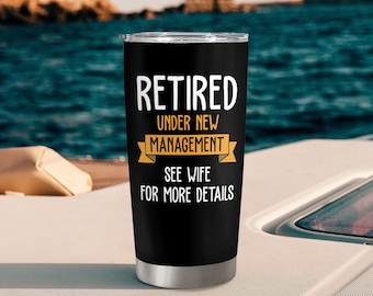 May include: A black stainless steel tumbler with a white inscription that reads "Retired Under New Management See Wife For More Details".