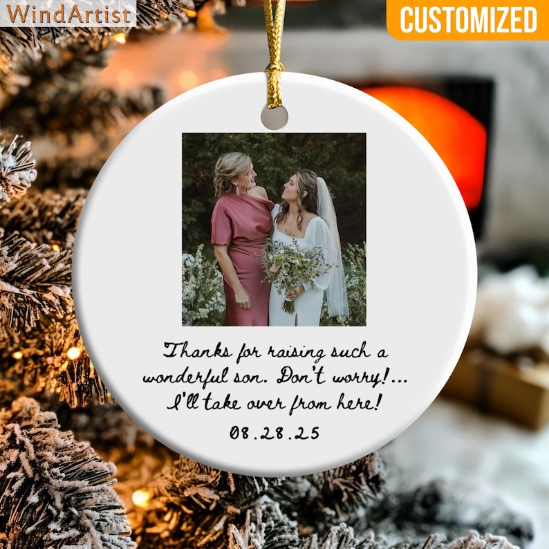 May include: White ceramic ornament with a gold string for hanging. The ornament features a photo of two women and text that reads, "Thanks for raising such a wonderful son. Don't worry!... I'll take over from here! 08.28.25". The word "CUSTOMIZED" is in the upper right corner.