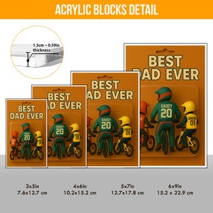 May include: Acrylic blocks with a 'Best Dad Ever' design. The blocks feature a father and child riding bikes, with the father wearing a green helmet and jersey with the number 20. The child wears a yellow helmet. Available in various sizes.